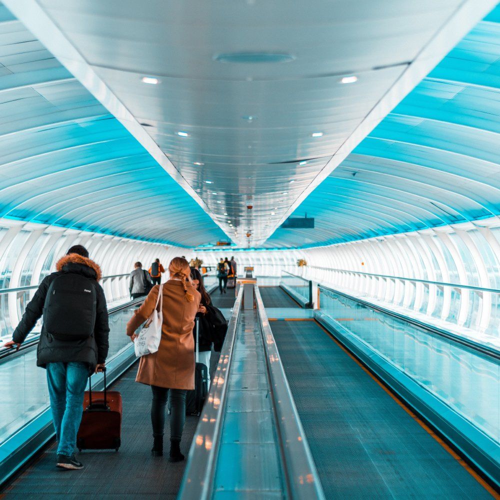 People in an airport on a moving walkway
